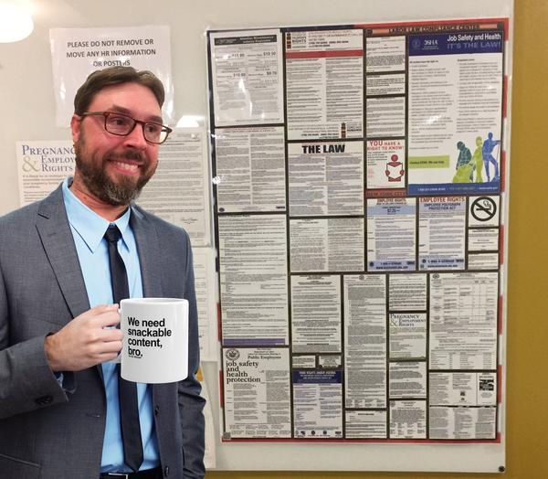 Dorky guy in suit holding mug that says, "We need snackable content."